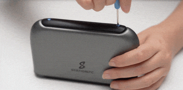 Using the screwdriver to loosen the screws and remove. the cover.